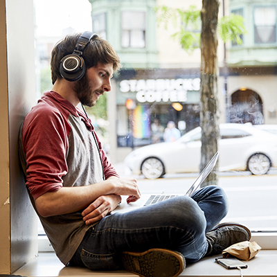 Music student studying in bay window at Berklee.