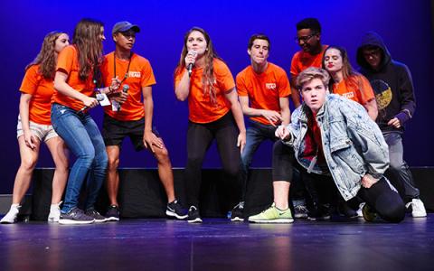 Students on stage during orientation