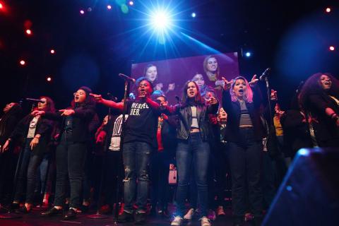 Student ensemble performing on stage.