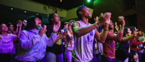 Audience members clapping at live Berklee concert